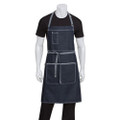 Dark indigo denim bib apron with grey contrast stitching, chest pocket and three front pockets, worn by male model