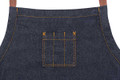Indigo denim bib apron with amber contrast stitching, divided chest pocket and tan leather neck strap
