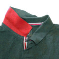 Forest green pique polo with red contrast collar and red, white, black striped placket trim
