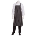 Black and white chalkstripe bib apron with adjustable neck strap and front pocket over white chef coat