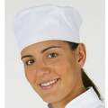 White chef beanie hat with elastic back worn by smiling chef showing rounded crown design