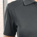 Charcoal grey textured polo shirt showing collar detail and shoulder panel construction with ribbed fabric finish
