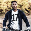 Black zip-up hooded jacket with white drawstrings worn over white printed t-shirt