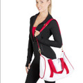 White canvas sports bag with red contrast handles and adjustable shoulder strap with silver clips