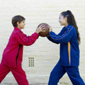 Kids wearing royal blue and hot pink micromesh tracksuits with contrast piping panels and side panels