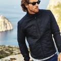 Navy quilted puffer jacket with stand collar, zip chest pocket and diagonal quilting pattern
