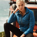 Sapphire blue quilted puffer jacket with stand collar and chest pocket worn over black leggings