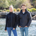 Black hooded jacket and navy hooded jacket with inner vest, modelled outdoors showing wind and waterproof construction