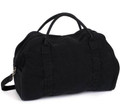 Black canvas duffle bag with dual carry handles and adjustable shoulder strap
