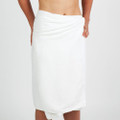 Model wearing white bamboo cotton wrap bath towel with gathered waist and knee-length coverage