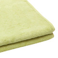 Folded lime green bamboo cotton fitness towel with ribbed hem detail visible