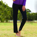 Black yoga tights with straight leg fit and purple zip-up jacket worn outdoors