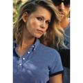 Heathered mid-blue pique polo with white button placket and short sleeves on female model