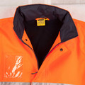 Orange and navy hi-vis safety jacket flat lay showing zip front, contrast collar lining, and clear ID pocket on chest