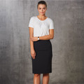 Model wearing a black mid-length pencil skirt with wide waistband, paired with a white scoop-neck top