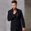 Male model wearing a navy wool blend stretch corporate jacket with notch lapels and two-button front