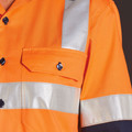 Hi-vis orange safety shirt with silver reflective tape bands and chest pocket with navy buttons