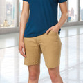 Tan chino shorts with navy polo shirt showing slim fit styling and side pockets