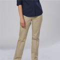 Model wearing sand beige straight-leg chino pants with clean flat front and tailored fit