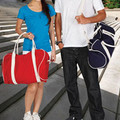 Canvas duffle bags in red and royal blue with natural cotton handles and contrast trim detailing