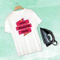 White t-shirt with bright pink heat transfer design displayed with iron on mint background