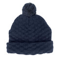 Navy blue knit beanie with textured basket weave pattern and matching pom pom on top