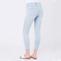 Rear view of ice blue ankle grazer denim jeggings with back pockets, worn with white sandals
