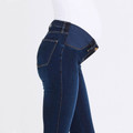 Side view of dark indigo maternity jeggings with stretch panel waistband, gold button detail and rear pocket stitching