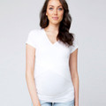 Model wearing white v-neck maternity tee with crossover nursing panel and ruched belly band