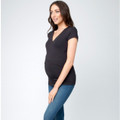 Pregnant model wearing black wrap-front nursing tee with V-neckline and short sleeves, styled with blue denim