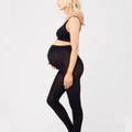 Black opaque maternity tights with supportive belly panel worn with matching crop top