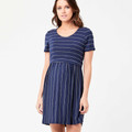 Model wearing indigo stripe short-sleeve nursing dress with gathered waist and flowy skirt