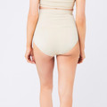 Natural beige high-waisted seamless brief with wide supportive waistband shown from rear view