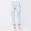Light blue boyfriend jeans with rolled cuffs and white back pockets, rear view on model