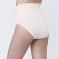 Model wearing nude high-waist maternity recovery compression briefs, rear three-quarter view