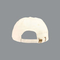 Back view of a cream washed cotton cap with brass buckle strap closure and structured six-panel construction