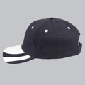 Navy cotton cap with white contrast peak and eyelets, adjustable back straps visible