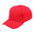 Red structured six-panel cap with white contrast sandwich brim and pique mesh texture