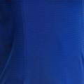 Close-up of royal blue polo fabric showing self-stripe texture and curved side panel seam