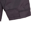 Charcoal grey jacket sleeve cuff with velcro adjustment tab and reinforced stitching detail