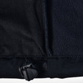 Close-up of navy softshell jacket hem zip detail showing contrast fleece lining and woven outer panel