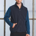 Navy polar fleece vest with full zip closure and side pockets, worn over teal long sleeves