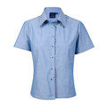 Women's short sleeve chambray shirt in light blue with button front and pointed collar, flat lay packshot