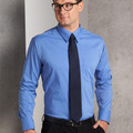 Man wearing a cornflower blue long sleeve dress shirt with chest pocket and dark navy tie