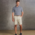 Stone beige cotton chino shorts with front pockets and belt loops, paired with navy gingham check shirt