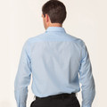 Rear view of man wearing a light blue pinstripe long sleeve dress shirt with back yoke panel and classic fit