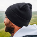 Charcoal grey ribbed knit beanie with turn-up cuff shown in profile view