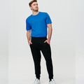 Black French terry jogger pants with elasticated cuffs and side pockets paired with royal blue tee
