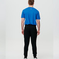 Back view of royal blue tee with black French terry jogger pants showing tapered fit and cuffed ankles