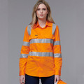 Woman wearing hi-vis orange long sleeve safety shirt with silver reflective tape across chest and sleeves